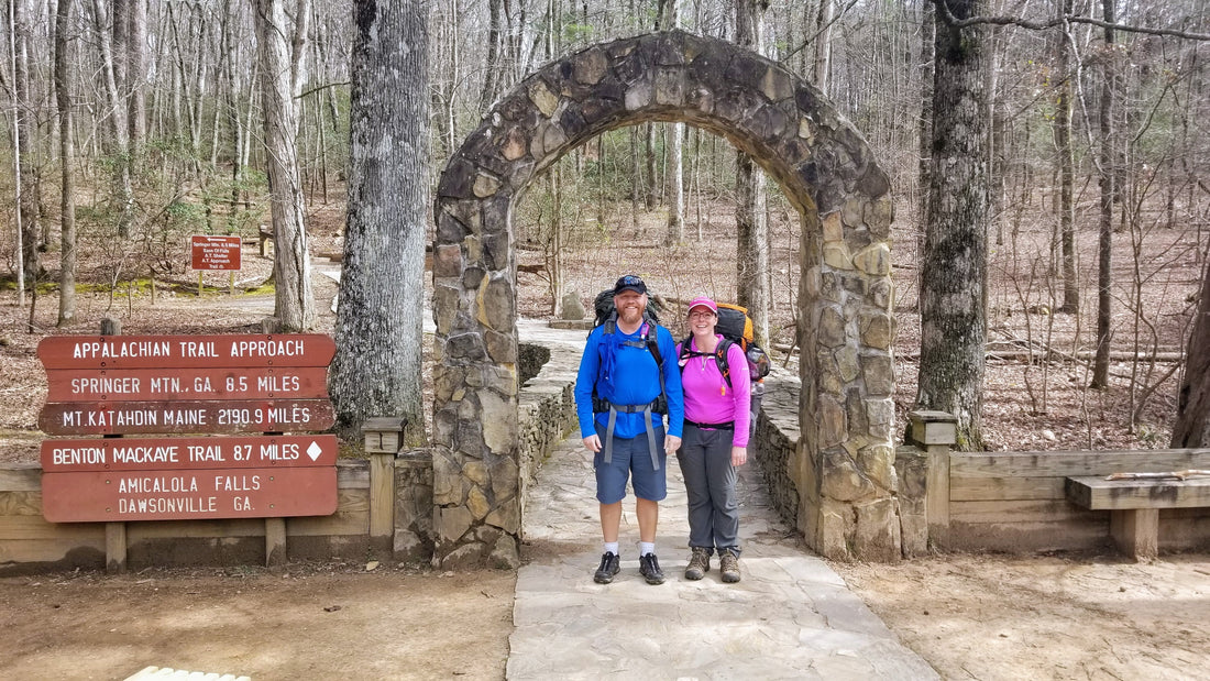 Jon and Missy Baatz standing under the famous Appalachian Trail approach arch at Amicalola Falls State Park.